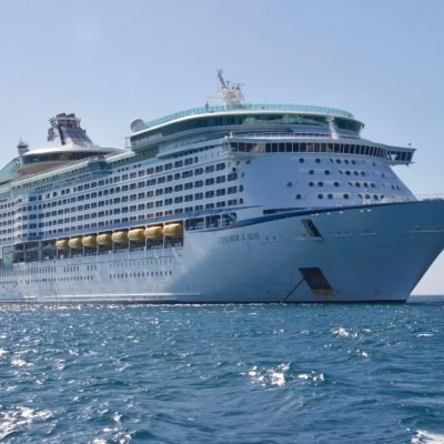 A luxurious cruise ship sailing on the ocean under a clear blue sky, ideal for travel and leisure.